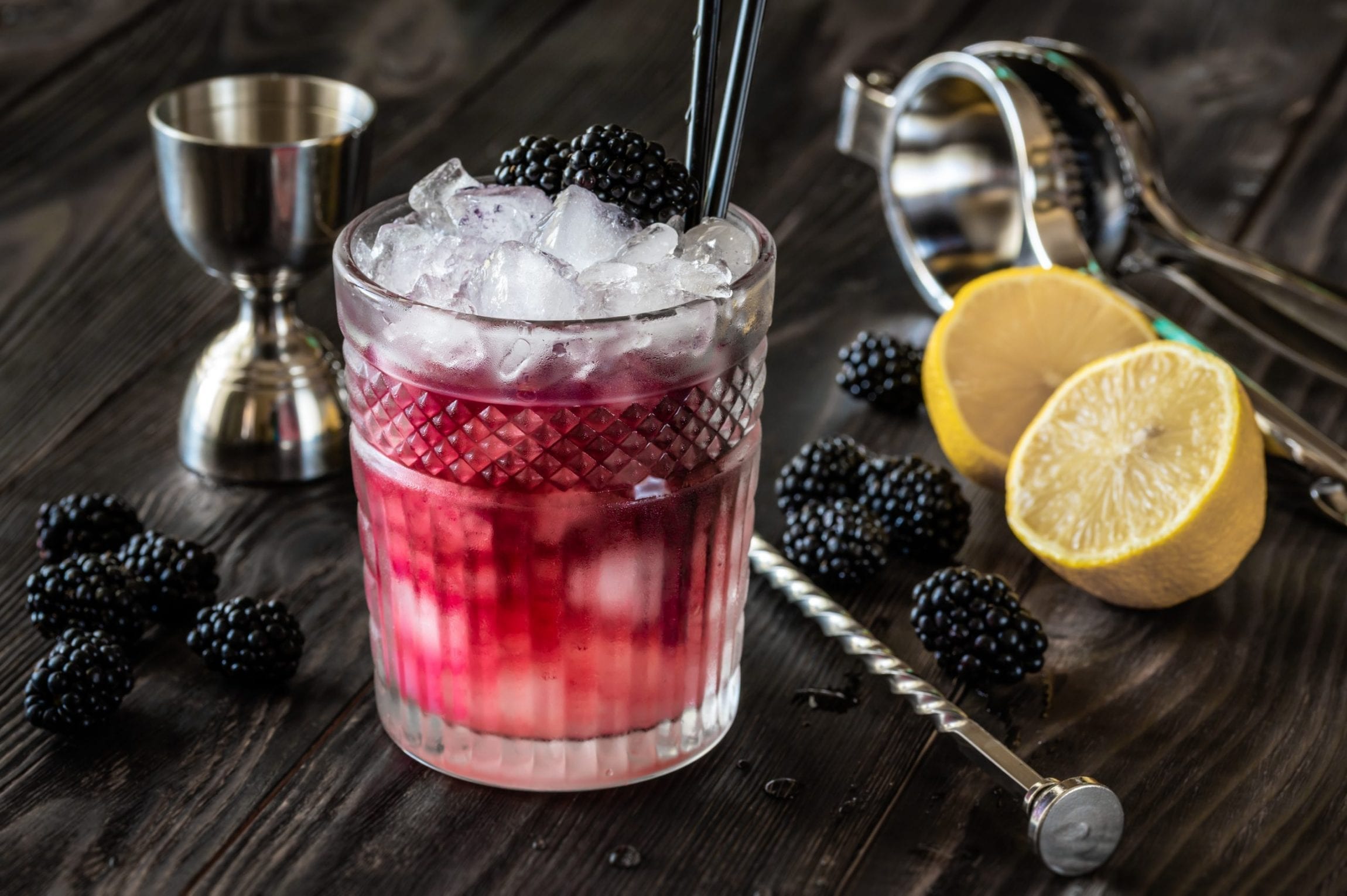 Glass of Bramble cocktail made of gin, lemon juice, sugar sypup and creme de mure