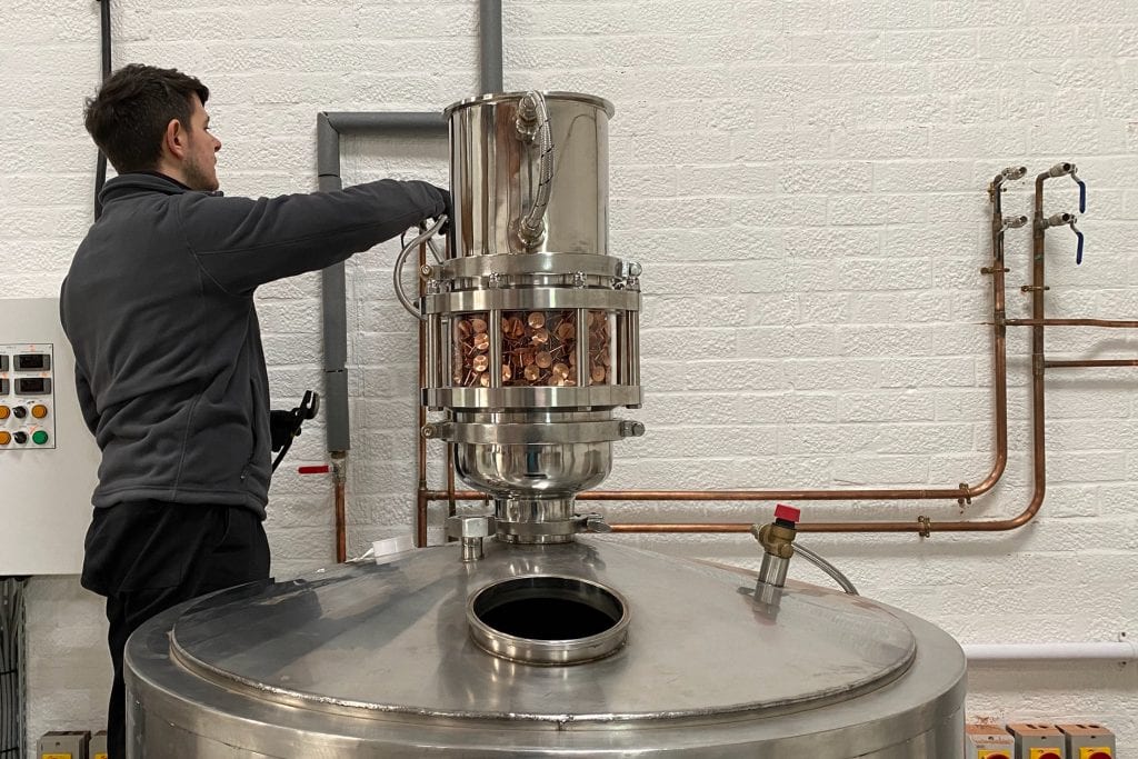 Head distiller, James Gibbons constructing a stainless-steel still with copper rivits